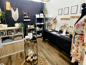 Shop photo with dress form, display tables and checkout counter